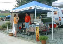 Buffalo Jack at the Durham Farmer's Market listening to a client.